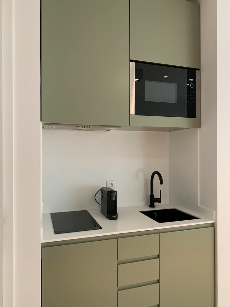 Cozinha verde pequena com puxadores cava e microondas embutido